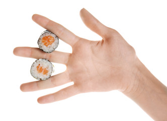 Female hand holding delicious sushi rolls, isolated on white