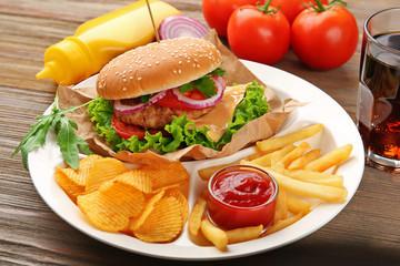 Tasty cheeseburger with fries and ketchup, closeup