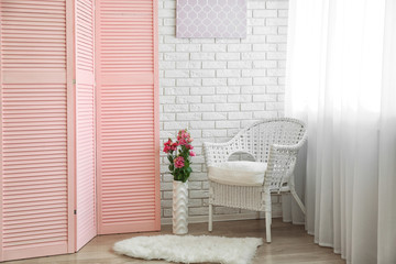 Light room interior with pink folding screen