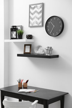 Shelves with home decor in modern room