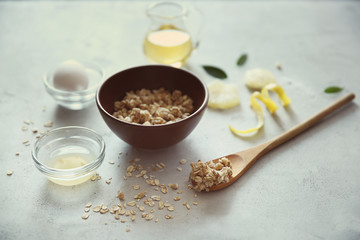 Natural scrub of oatmeal, olive oil and lemon on light background