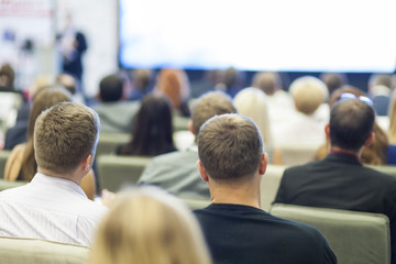 Professional Male Host Speaking in Front of the Audience During Presentation