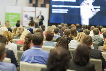 Obraz premium Male Host Speaking in Front of the Audience During Business Conference