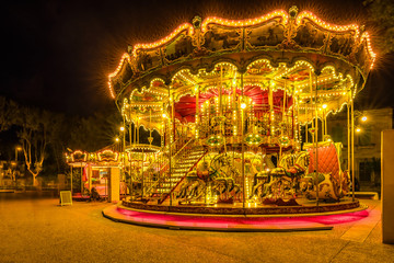 Brightly illuminated traditional carousel in Paris France at night...