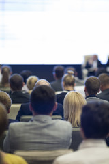 People at the Conference Watching  Presentation on Screen in Front