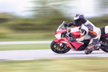 Motorcycle leaning into a fast corner on highway