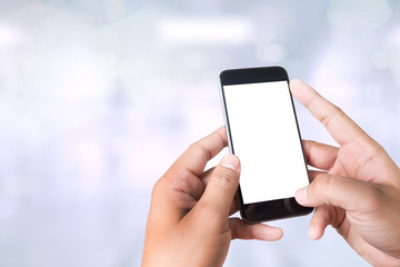 person holding a smartphone on blurred cityscape background