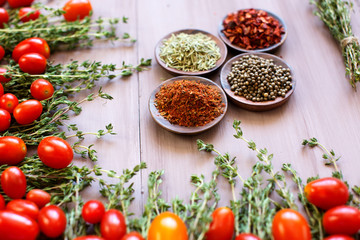 Still life with tomatoes, herbs and spices.