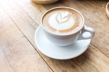 Cup of coffee latte art on wood table