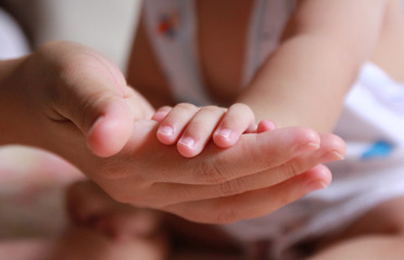 Close Up holding baby hand