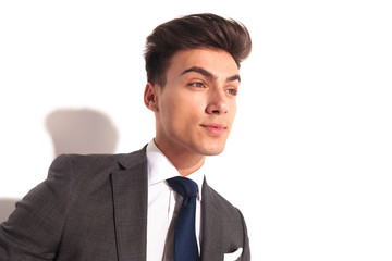 closeup picture of a young business man looking to side