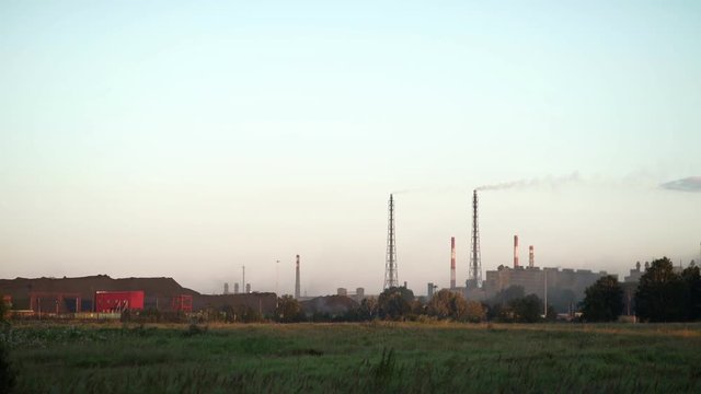 Smoke goes from the chimney. Industrial pipe. From pipe goes smoke. Air pollution. Factory in the contryside The plant is located in the city.