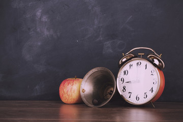 Bell, alarm clock and bell against a blackboard Vintage Retro Fi