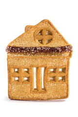 Печенье в виде домика крупным планом на белом фоне
