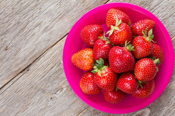 Strawberries on old wooden floor.