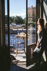 woman standing and a balcony with views of the Saint-Petersburg