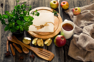still life of wooden utensils with mint and apples