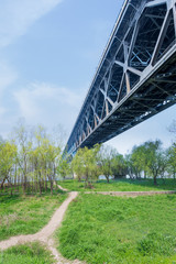 Bridge Over Grassy Landscape with skyline.