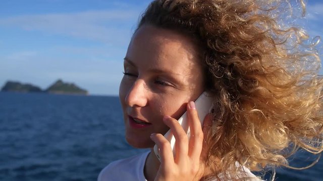 Young Woman Talking By Mobile Phone Sailing in Sea