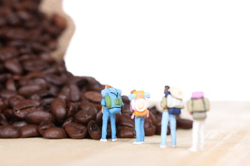miniature people with coffee beans.