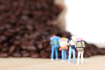 miniature people with coffee beans.