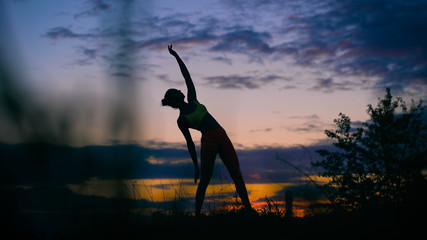 carefree woman dancing in the sunset. vacation vitality healthy living concept.