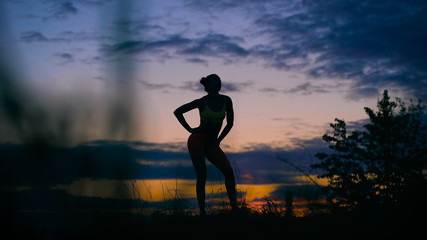 carefree woman dancing in the sunset. vacation vitality healthy living concept.