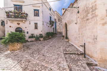 Fototapeta na wymiar typical old street view of Matera under blue sky