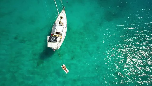 aerial view of a people relaxing on a sailboat in the Caribbean