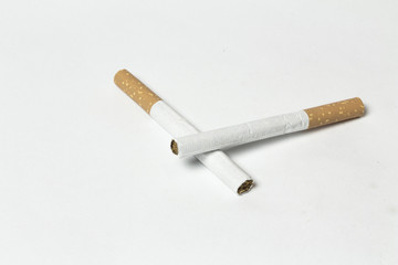 Two crossed Cigarettes on white background