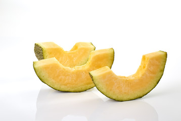 Hamigua Melon cut into slices, Hami Melon, Hami Cantaloupe isolated on white background. stack imag