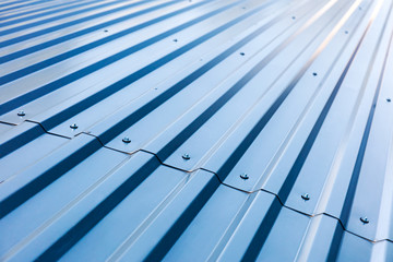 blue corrugated metal roof with rivets, industrial background  - obrazy, fototapety, plakaty