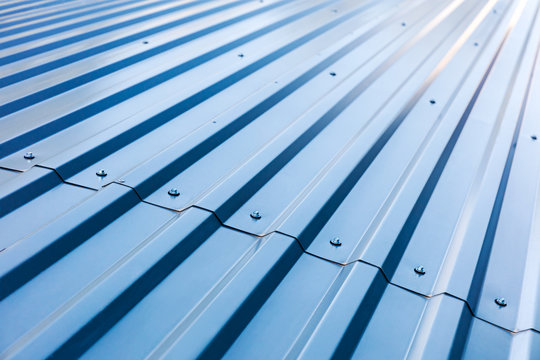 blue corrugated metal roof with rivets, industrial background 