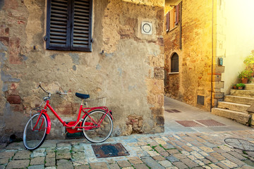 Old Mediterranean town street with red retro bike