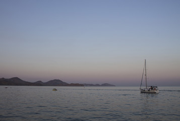 Fototapeta premium Sailboat at sunset in the Black Sea. Crimea, summer 2015