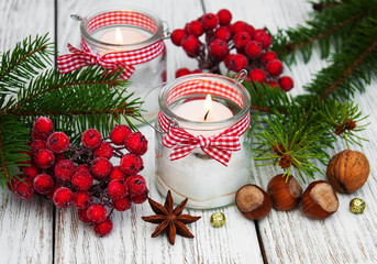 christmas decorations candles in glass jars with fir