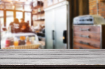 Selected focus empty brown wooden table and Coffee shop blur bac