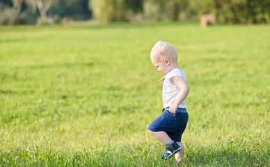 Blond toddler boy in the nature