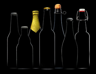 Set of beer bottles with clipping path isolated on black gradient background