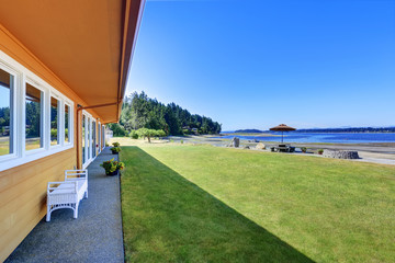 Back yard with stone patio table set and water view