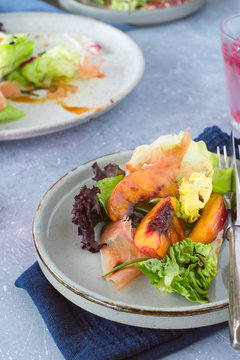 Mixed green salad with prosciutto and grilled nectarine slices