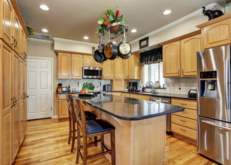 Kitchen room interior in Luxury home with maple cabinets.