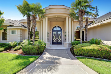 Fototapeta na wymiar Suburban luxury house with column porch and arched entrance door