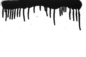 Black color spray paint on a white background paper