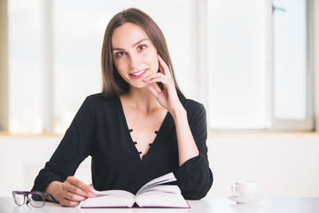 Charming woman with open book