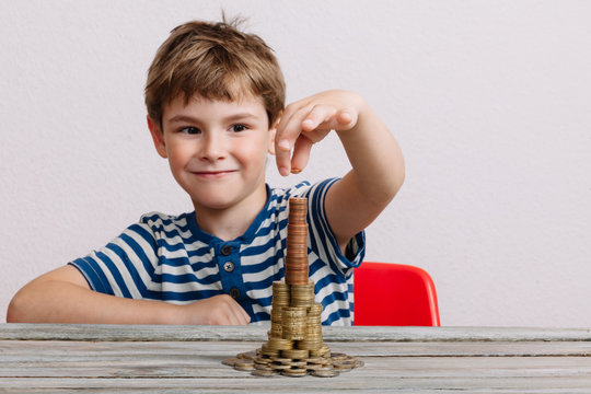 Boy building stack of cash