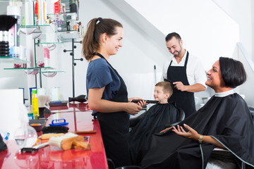 hairdresser talking with client in beauty salon .