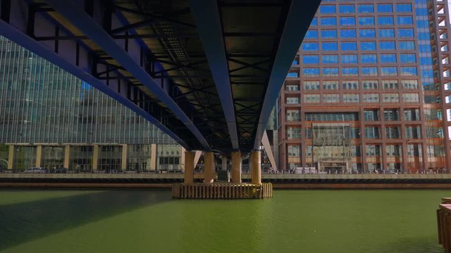 A panning shot under the DLR train bridge in the Docklands District (Canary Wharf) of London, UK

