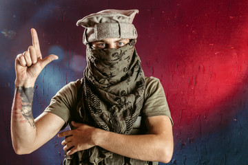 Portrait of terrorist with finger gun sign