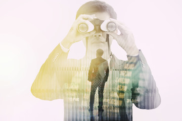 Double exposure businessman searching binoculars outdoors